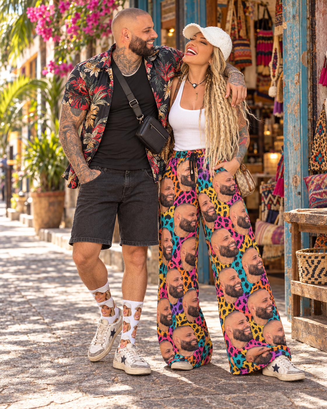 Eric wearing socks printed with Kimba's face beside Kimba wearing colorful pants printed with Eric's face